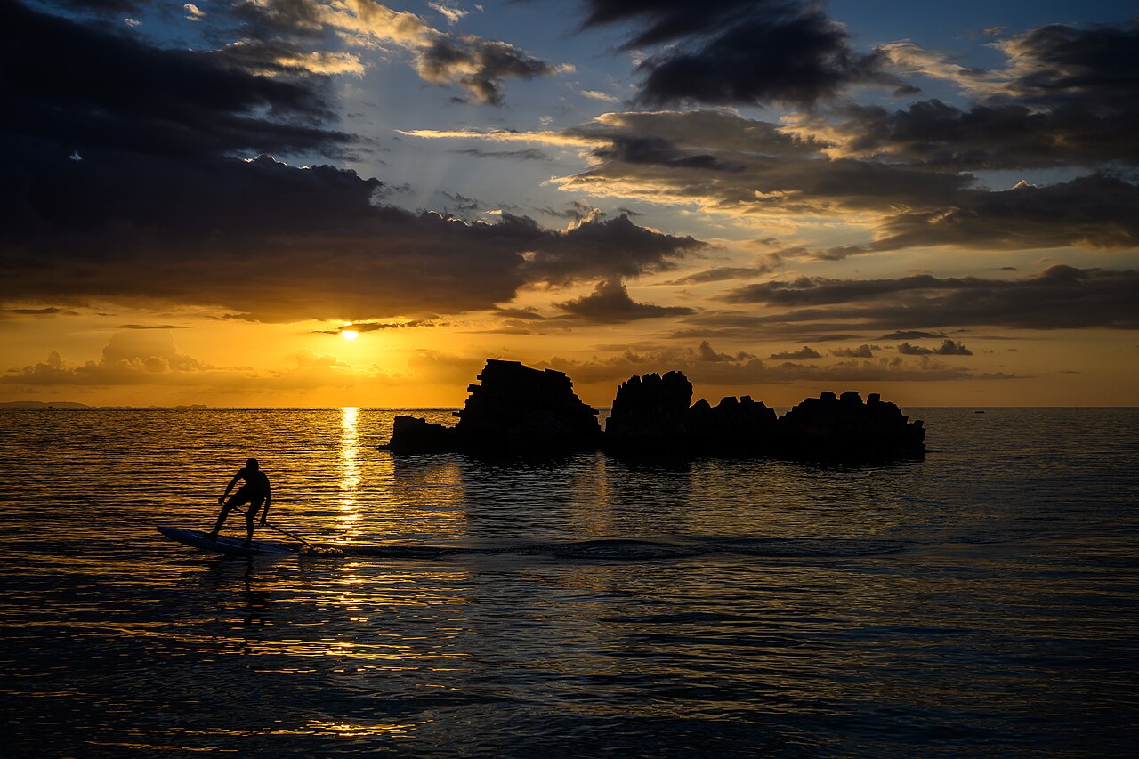 Paddleboarding at sunset along Chatan's coast